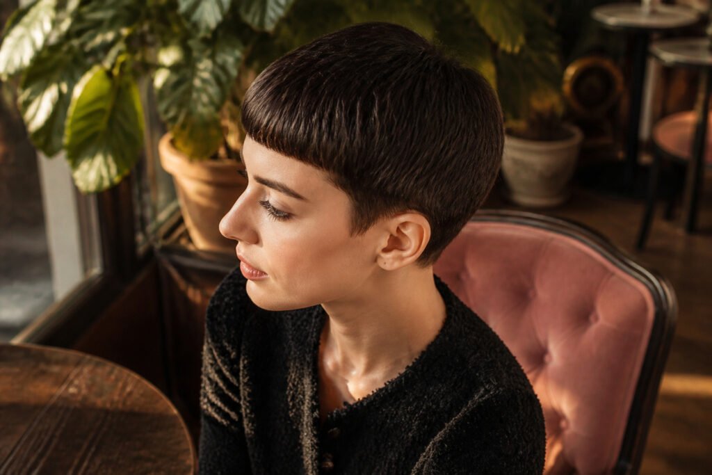 Anne Hathaway with a 1960s-inspired pixie cut and blunt fringe.