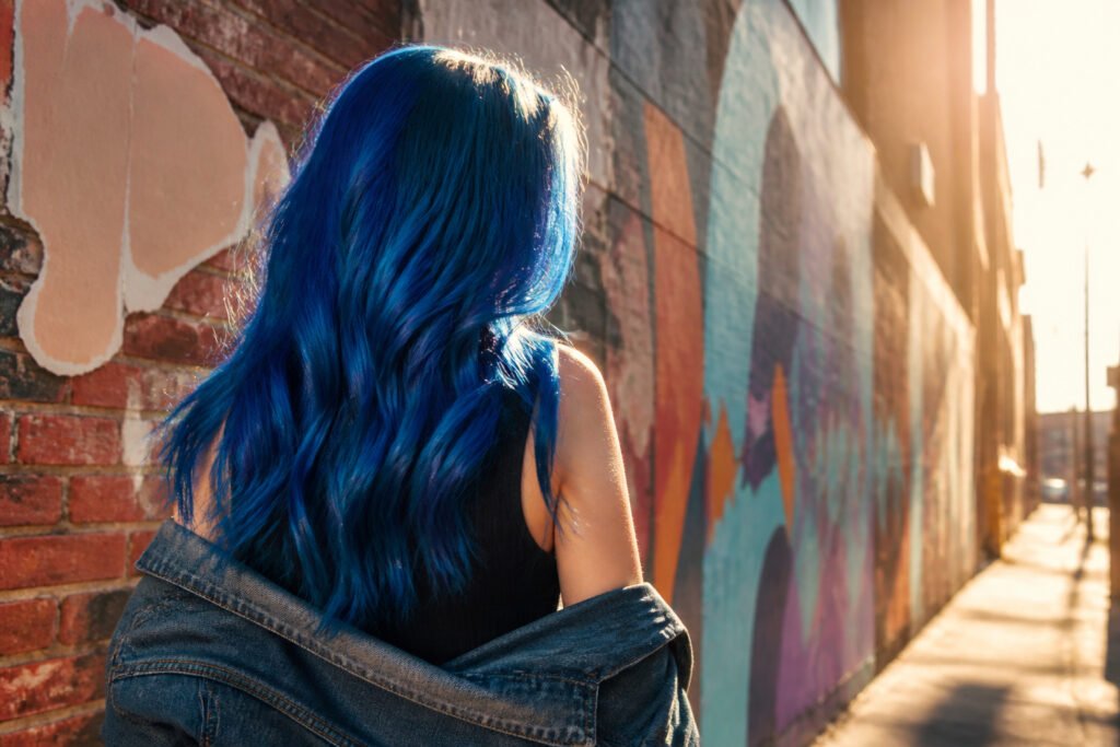 Model with various shades of blue hair in a creative setting.