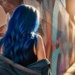 Model with various shades of blue hair in a creative setting.