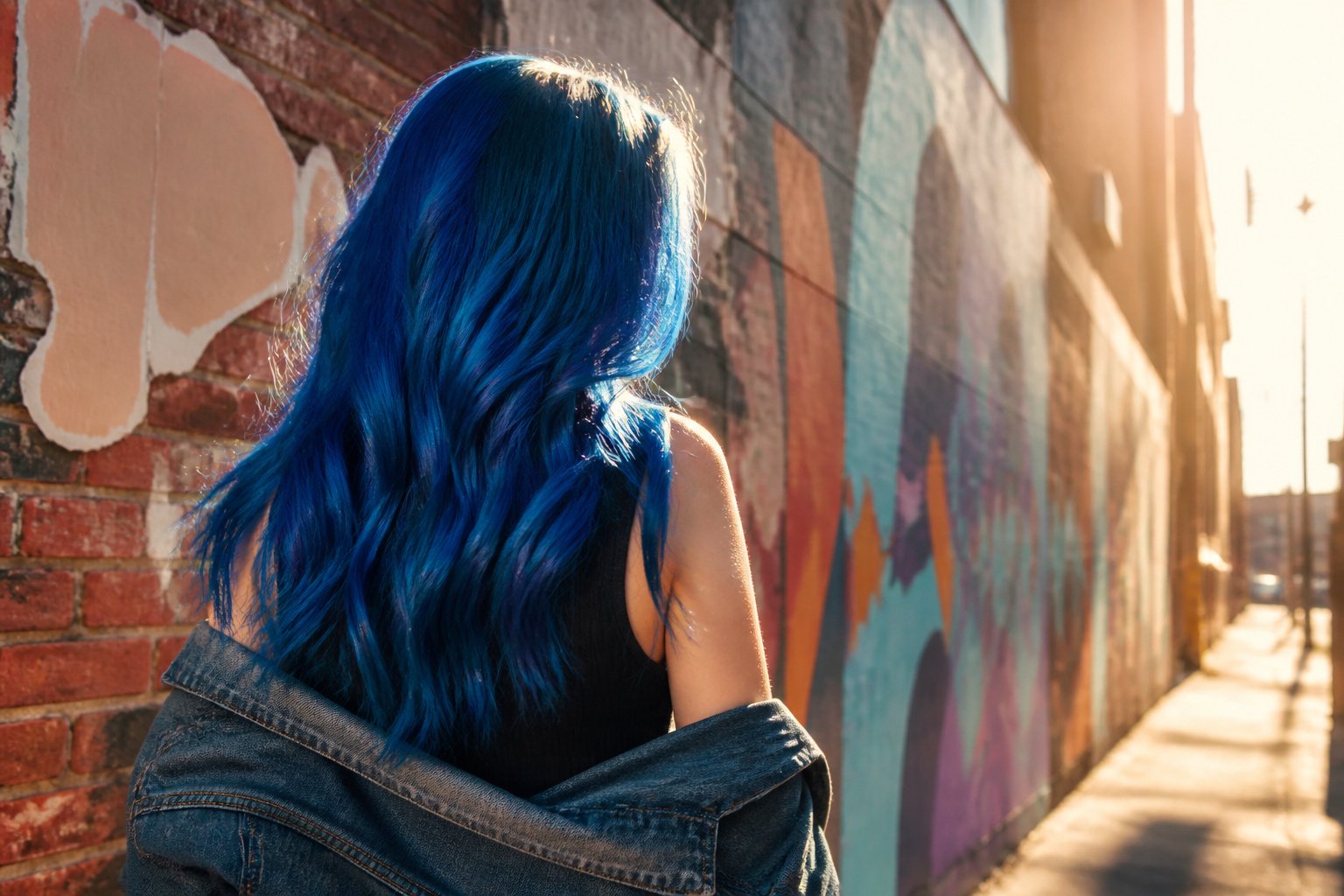 Model with various shades of blue hair in a creative setting.